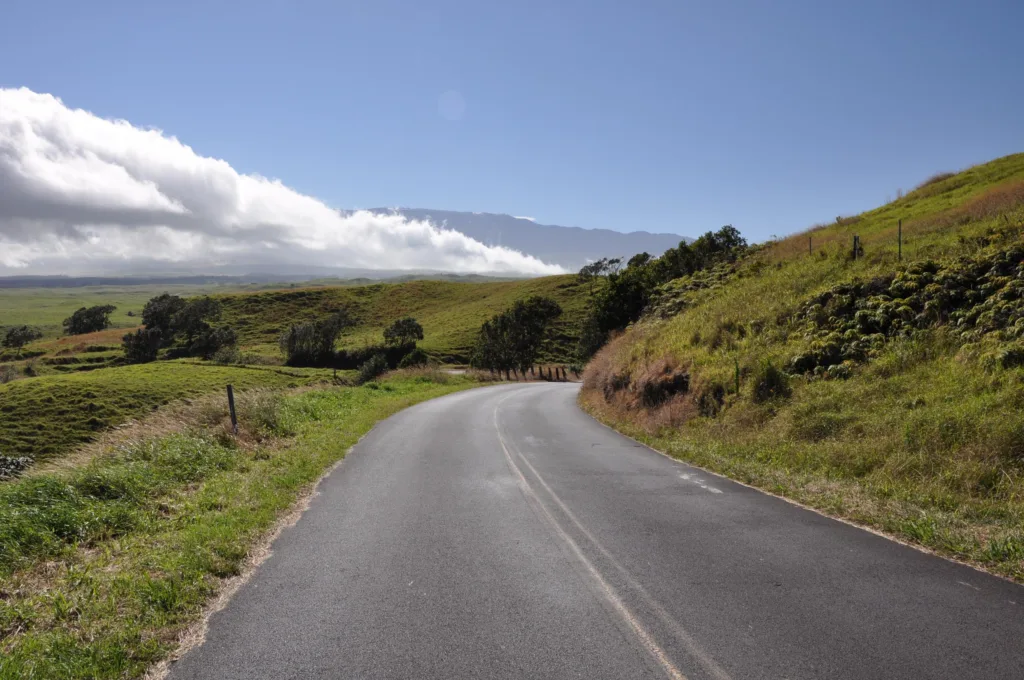 Cyclists riding along Sugar Cane Road near volcano