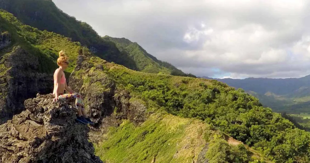 Hikers walking along lush tropical forest trail