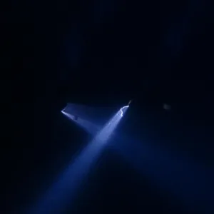 Night scuba diver exploring deep ocean pelagic zone