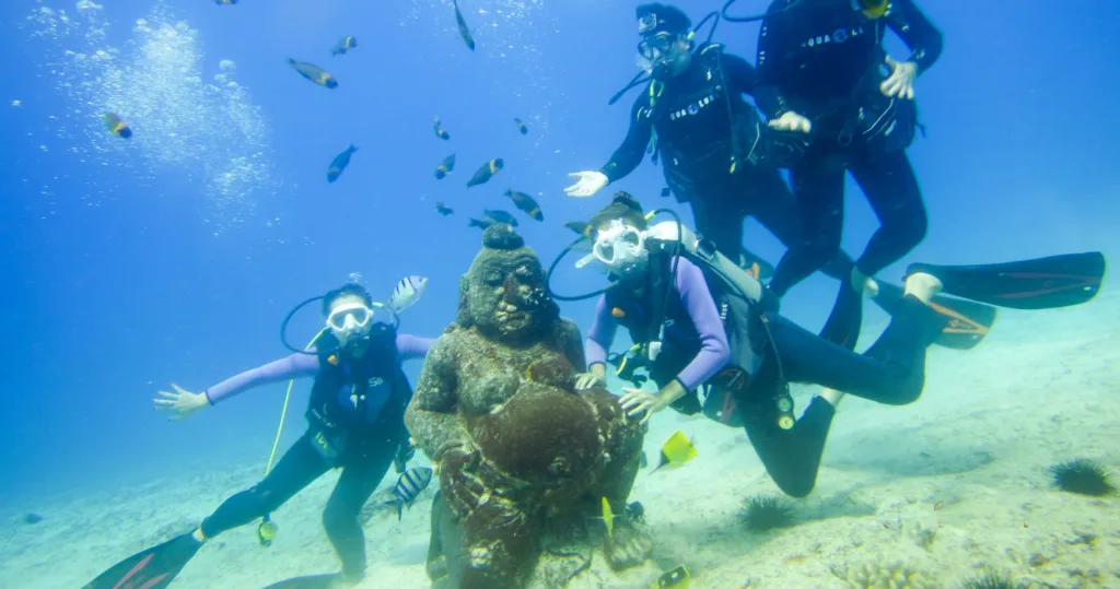 Scuba diving beginners exploring shallow Hawaiian reef