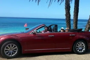 Luxury convertible driving along Oahu’s North Shore coast