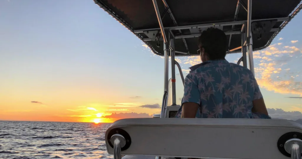 Sunrise cruise boat sailing along Hawaii’s coastline