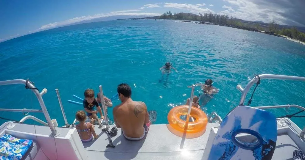 Private boat cruising near tropical Hawaiian coastline