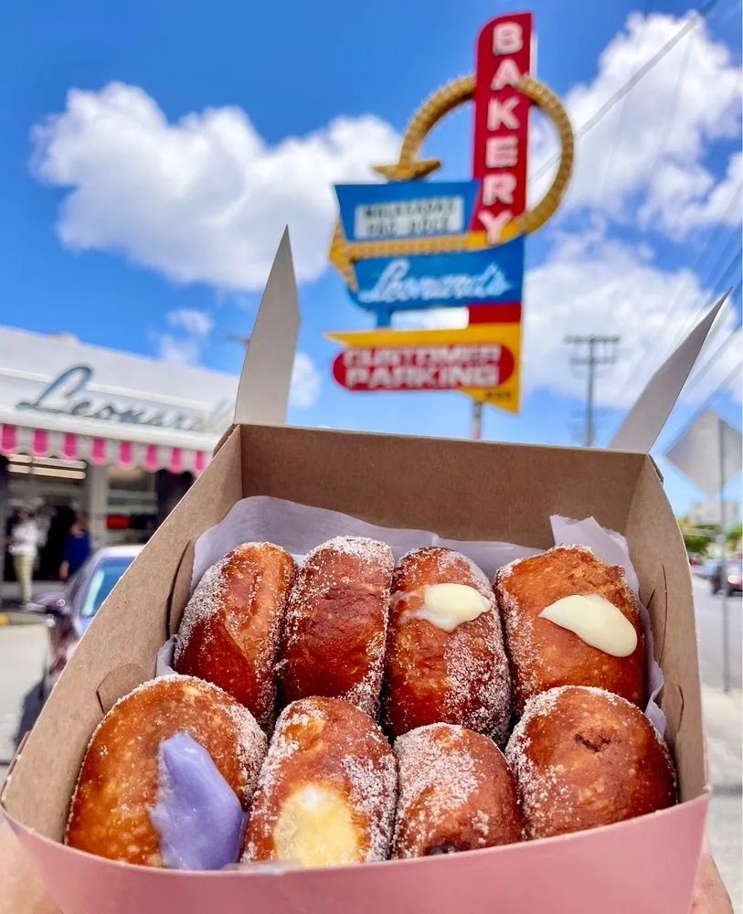 Slingshot vehicle parked near local food trucks