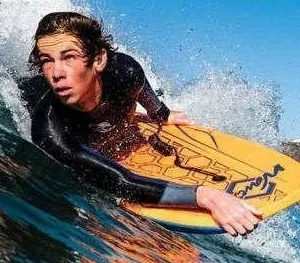 Boogie board resting on sandy beach near ocean