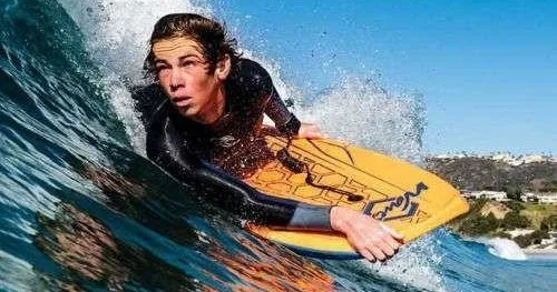 Boogie board resting on sandy beach near ocean