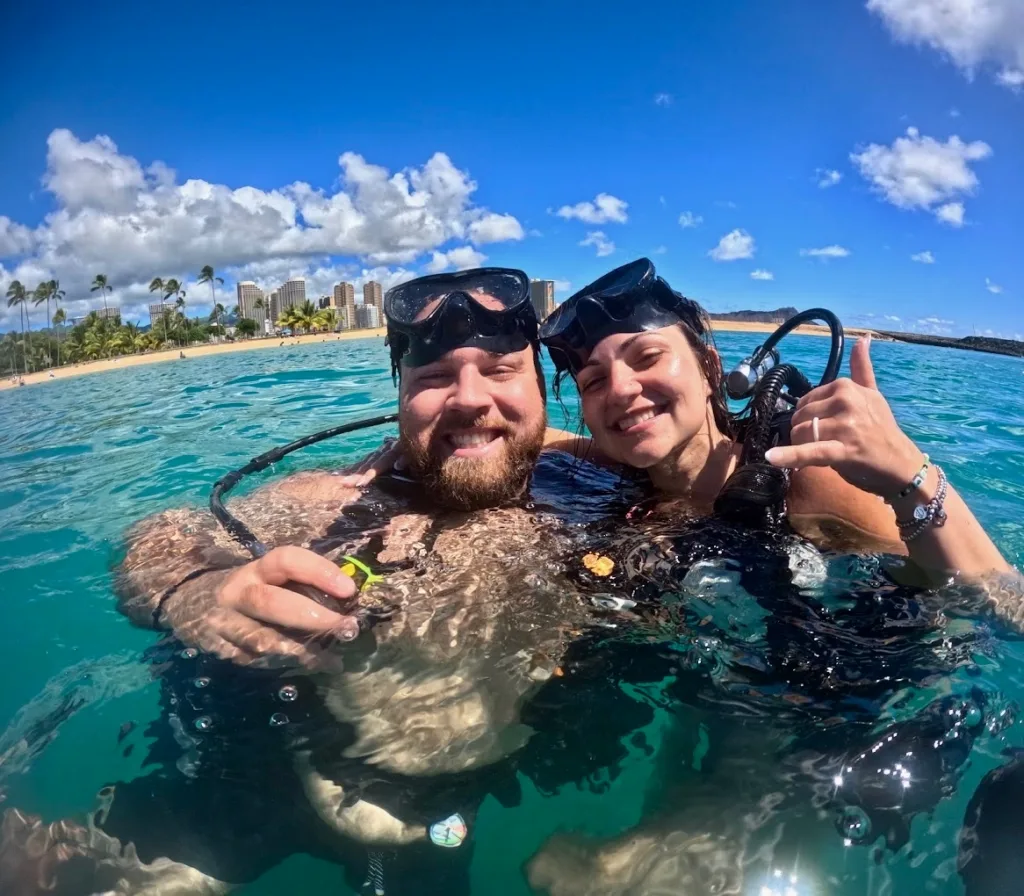 Beginner scuba diver practicing skills in shallow water