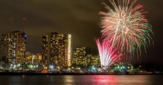 Catamaran sailing in Waikiki during Fourth of July fireworks