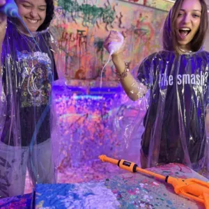 Person wearing poncho holding paint blaster