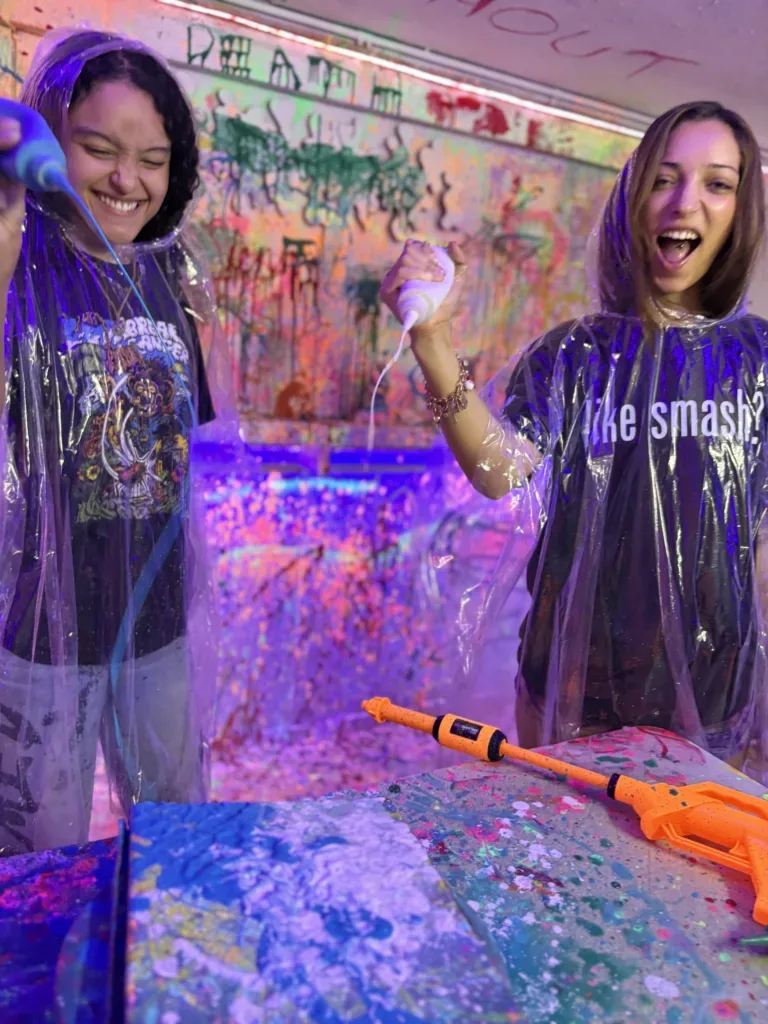 Person wearing poncho holding paint blaster