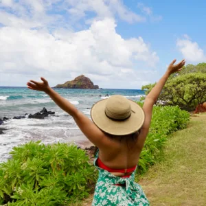 Luxury vehicle parked near tropical waterfall