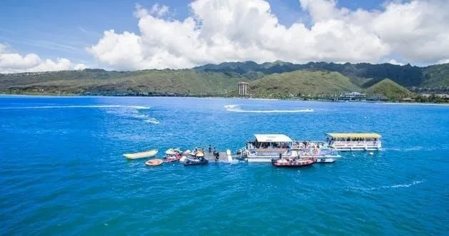 People enjoying jet skiing on clear Hawaiian waters