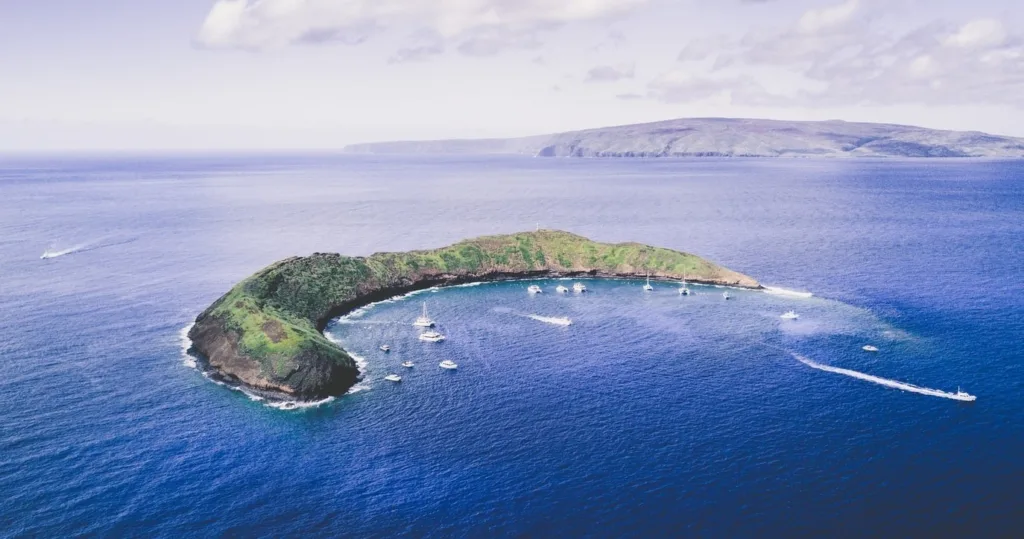 Scuba diver exploring Molokini Crater underwater