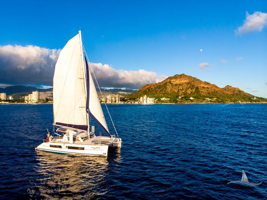 Luxury catamaran sailing near Waikiki coastline