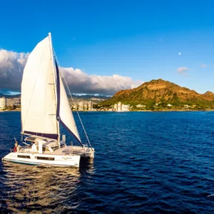 Luxury catamaran sailing near Waikiki coastline