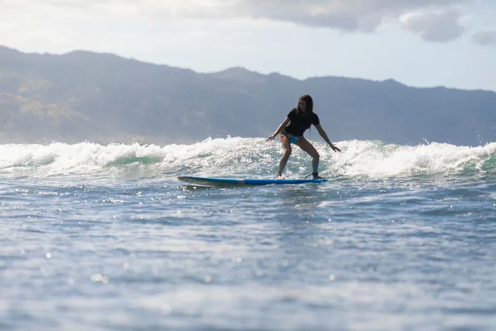 Surfer riding a wave during lesson