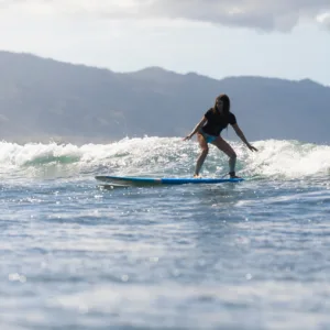 Surfer riding a wave during lesson