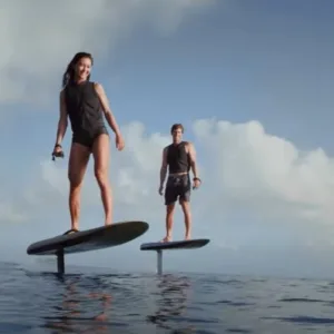 Person learning to eFoil on clear ocean water