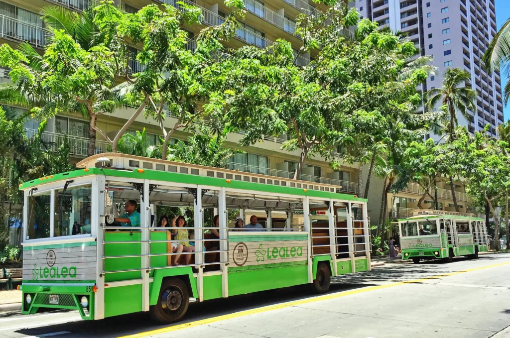 Colorful trolley bus driving through Waikiki streets