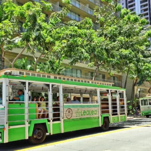 Colorful trolley bus driving through Waikiki streets