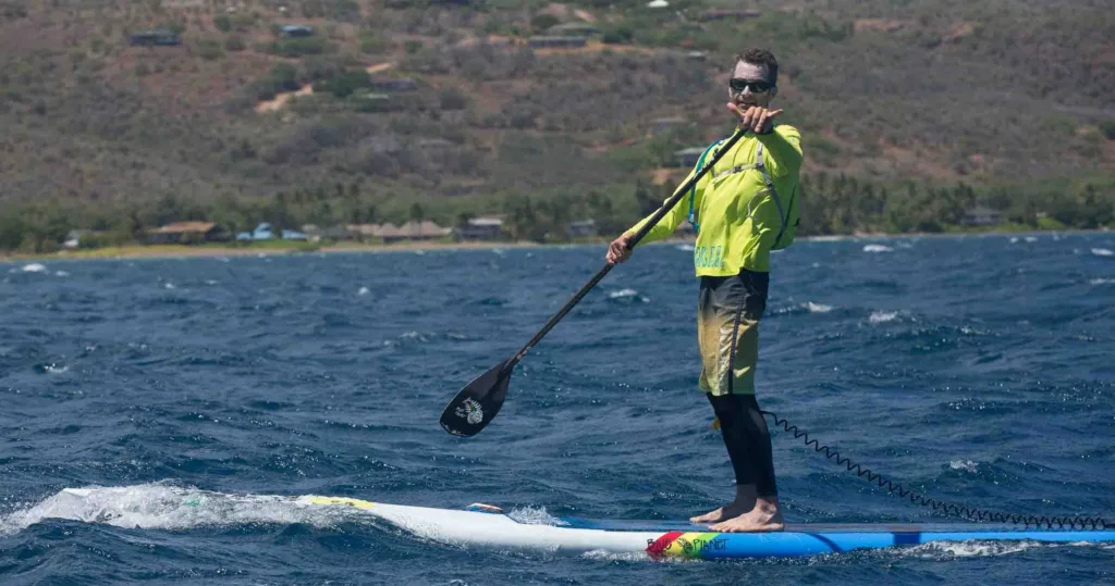 Single and double kayaks lined up on the beach