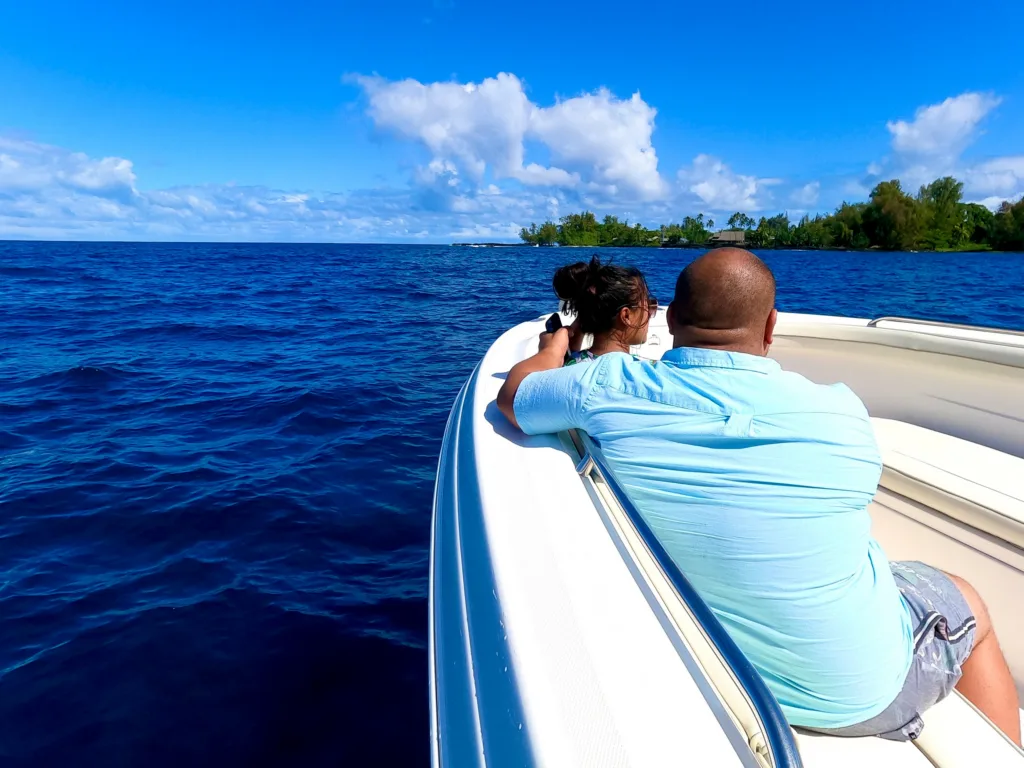 Private boat cruising along East Hawaii coastline