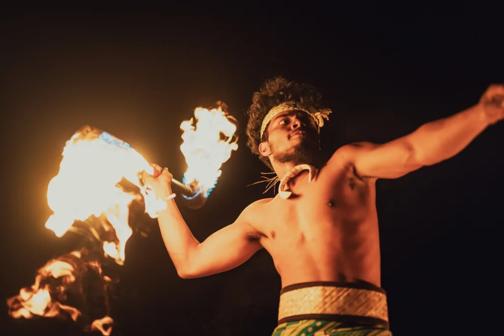 Luau stage with performers in traditional warrior attire