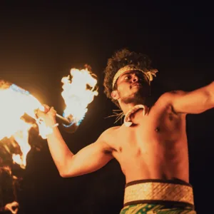 Luau stage with performers in traditional warrior attire