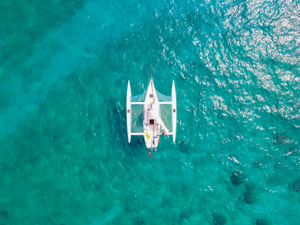 Sailboat anchored in calm Waikiki waters for swim tour
