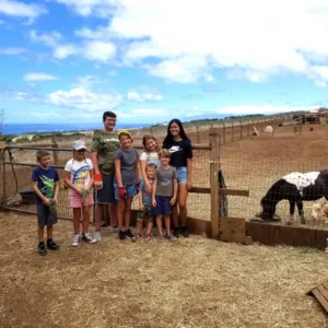 Children petting goats at a private petting zoo farm