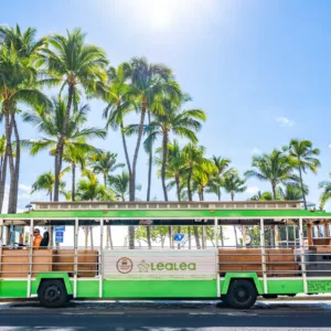 Colorful trolley bus driving through Waikiki streets