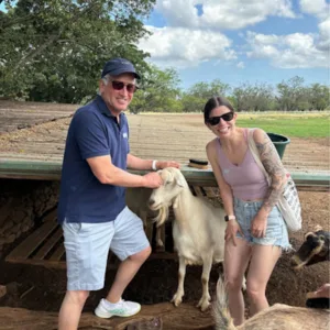 Person cuddling a friendly goat during experience