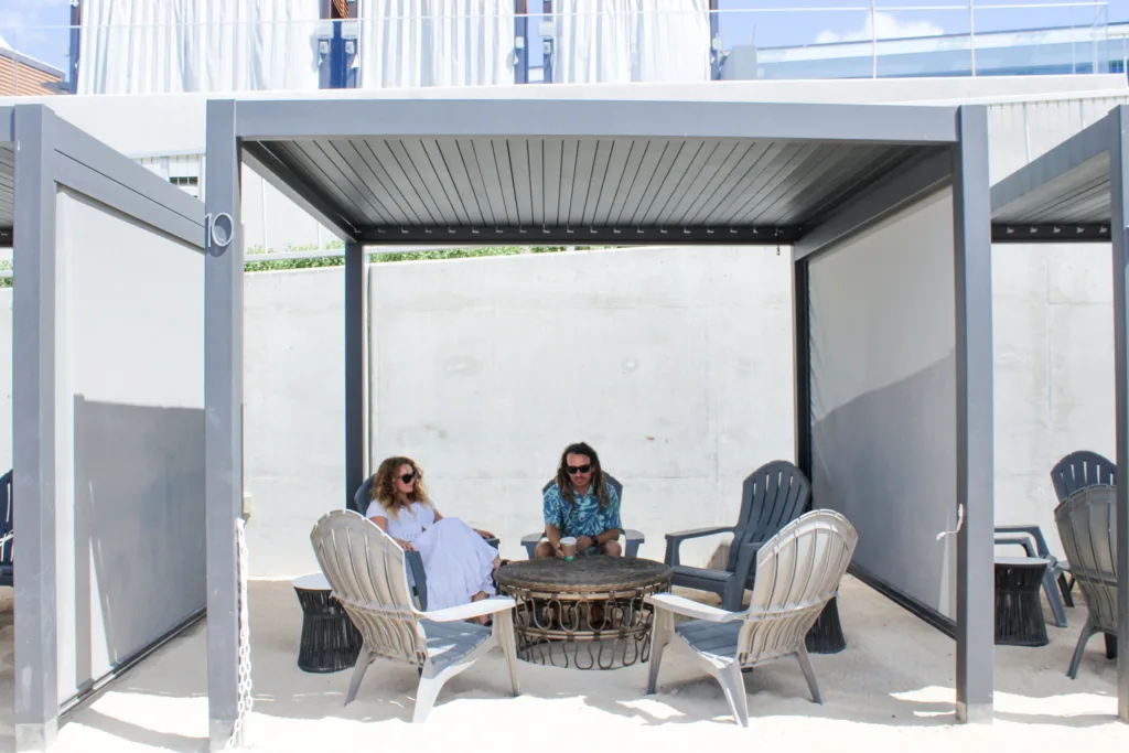 Waterfront cabana with lounge chairs overlooking lagoon