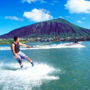 Wakeboarder learning to ride in tropical marina