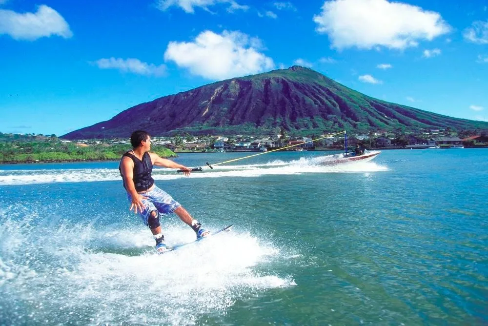 Wakeboarder learning to ride in tropical marina