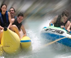 Six people holding on to a bright yellow banana boat