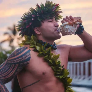 Traditional Hawaiian luau setup with tiki torches and tables