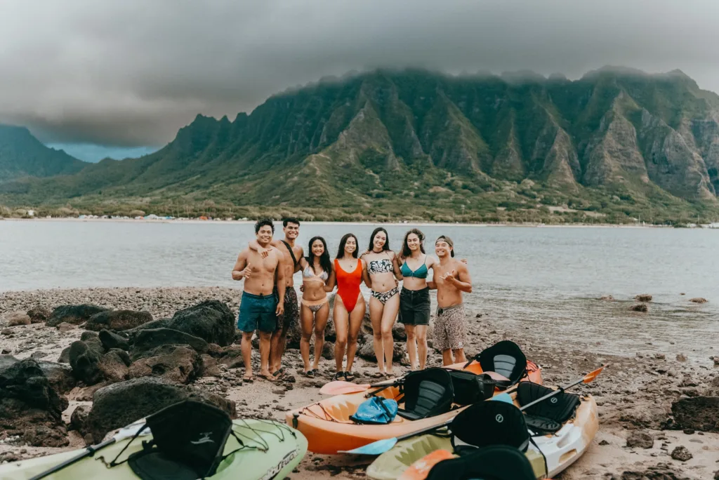 Kayak and beach gear laid out on sandy shore