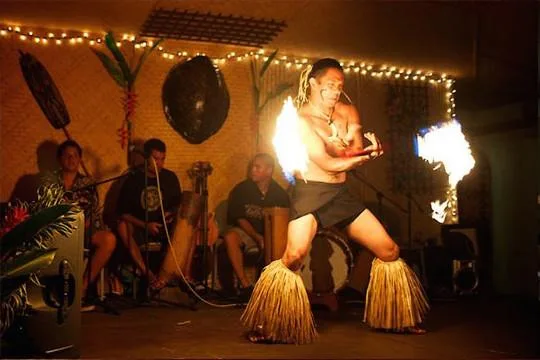 People enjoying traditional Hawaiian luau feast outdoors