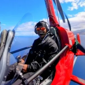 Two people flying gyroplanes over Kona coast