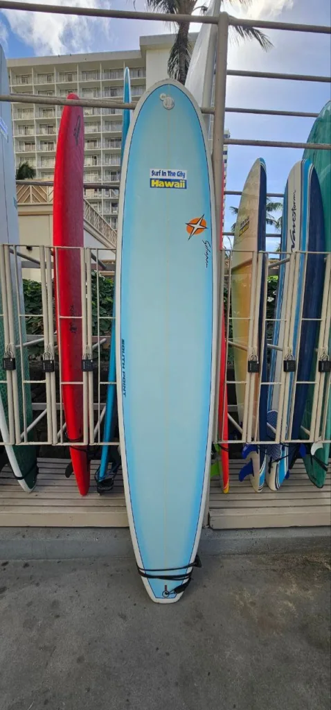 9ft8in Schaper epoxy surfboard resting near locker