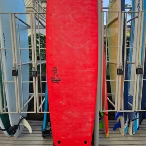 Red 9-foot soft surfboard leaning against locker