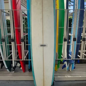 9ft fiberglass surfboard leaning against Waikiki locker