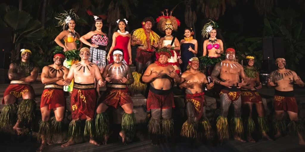Luau guests tasting traditional Hawaiian foods