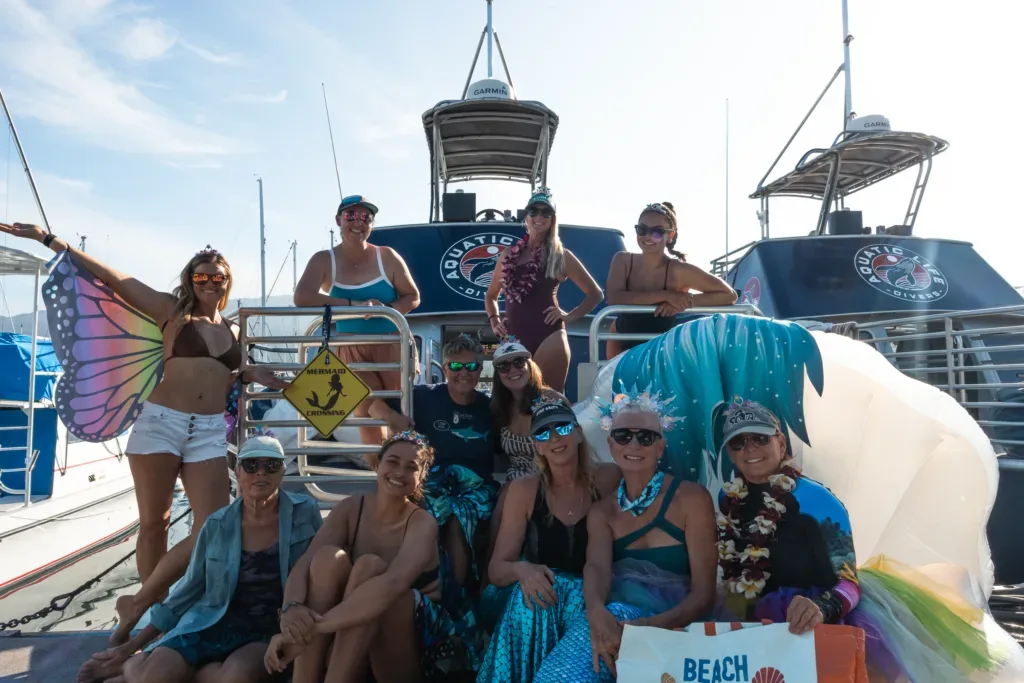 Women divers preparing gear on boat deck