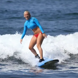 Surfer riding waves at Kailua-Kona beach