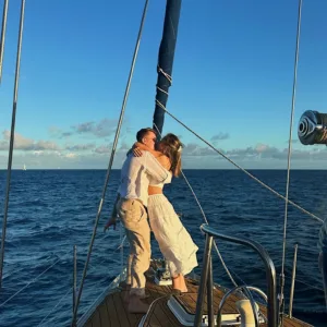 Couple enjoying a private sailboat on calm ocean waters