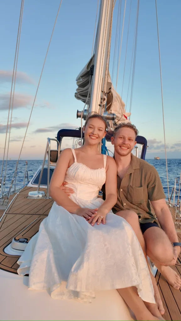 Couple getting married on a private sailboat at sea