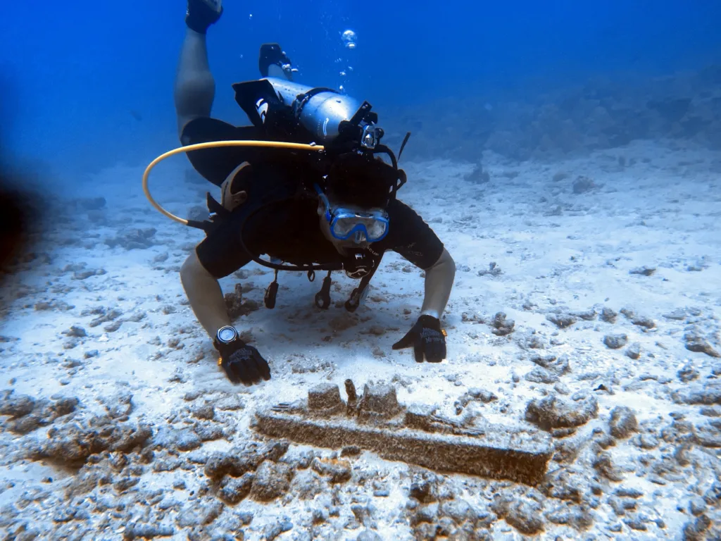 Scuba gear laid out on beach before dive