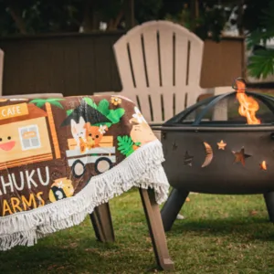 Guests gathered around a warm bonfire at Kahuku Farms